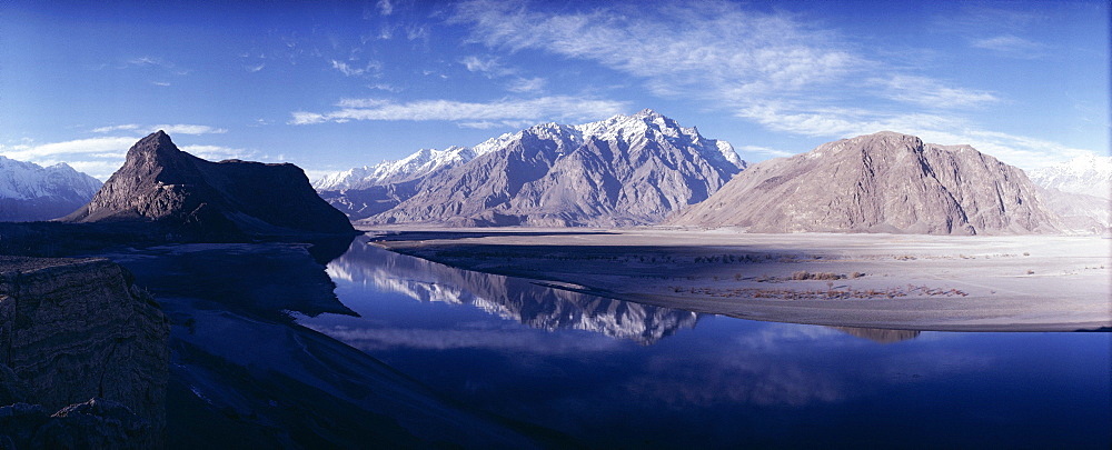 Panorama of mountains reflected in the water of the Indus River, Skardu, Baltistan, Pakistan, Asia