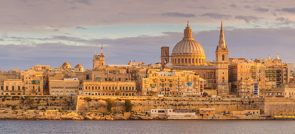 Valletta skyline panorama at sunset with the Carmelite Church dome and St. Pauls Anglican Cathedral, Valletta, Malta, Mediterranean, Europe