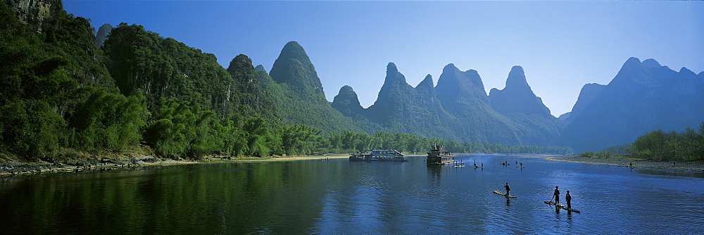 Fishermen on bamboo raft in Lijiang river, Guilin, China