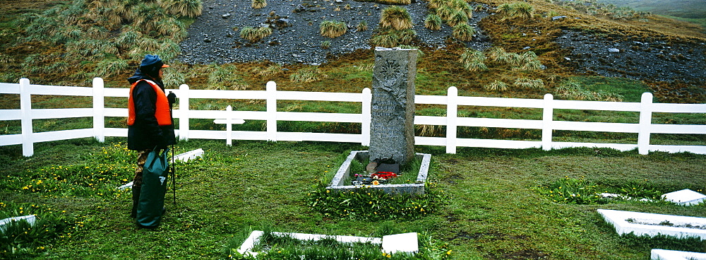 Tourist at Shackleton's Grave, Grytviken, South Georgia, South America