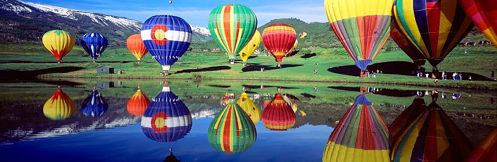 Reflection of hot air balloons on water, Colorado, USA