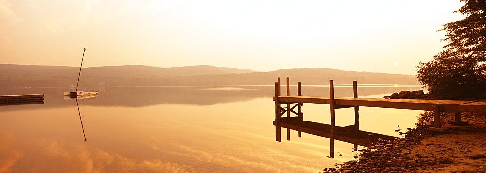 Pier on a lake at sunset, Pleasant Lake, New Hampshire, USA