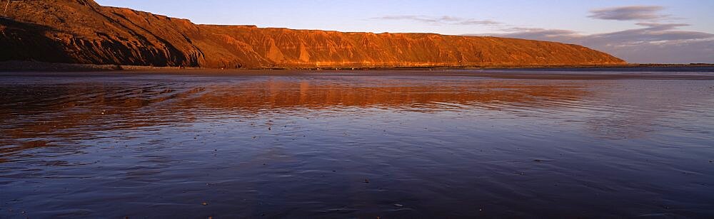 Reflection of a hill in water, Filey Brigg, Scarborough, England, United Kingdom