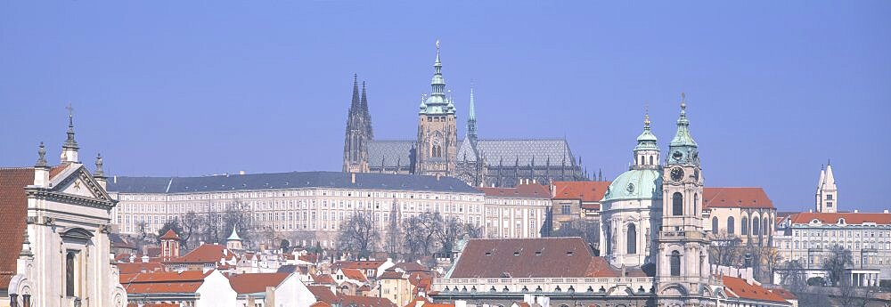 Low angle view of a church and a castle, Hradcany Castle, St. Nicholas Church, Prague, Czech Republic