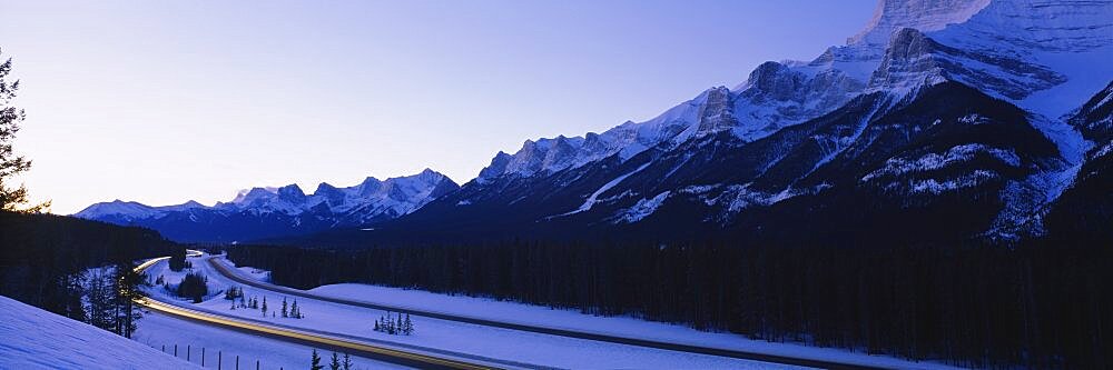 Low angle view of snowcapped mountains, Mt Rundle, Three Sisters, Canmore, Alberta, Canada