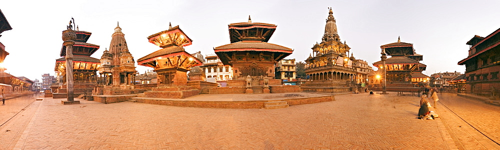 Buildings in Durbar Square, from the left, Hari Shankar Mandir, statue of Yoganarendra Malla on pillar, shikhara style temple, two pagoda roofed temples the right hand unlit one being the Jagan Naryan Mandir, the shikhara style Krishna Mandir, column topped by Garuda, the Bishwanath Mandir and on the extreme right the Patan Museum in the Old Royal Palace, UNESCO World Heritage Site, Patan, Kathmandu Valley, Nepal, Asia