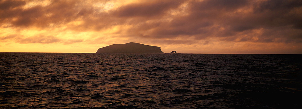 Spectacular sea arch off the volcanic cliffs of Darwin Island one of the newest and most northerly of the Galapagos Islands, Ecuador