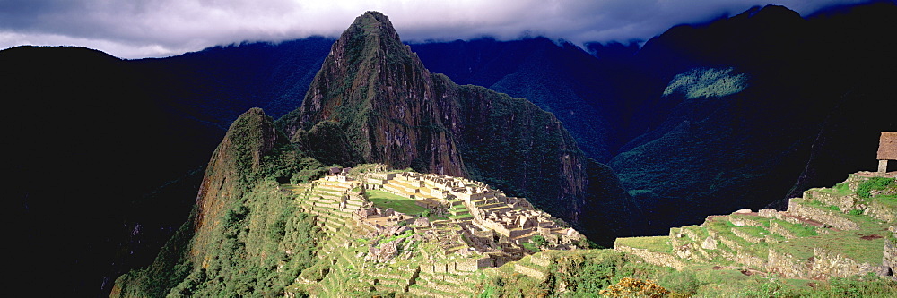 Machu Picchu view of the ancient city with Huayna Picchu peak above on the Rio Urubamba in the Vilcabamba Mountains,, Highlands, Peru