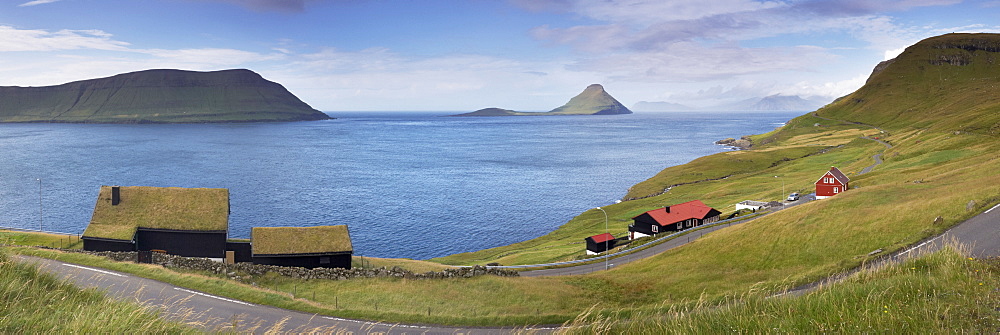 Panoramic view of Velbastadur village, turf-roofed houses, Hestfjordur, Hestur on the left, and Koltur islands in the distance, Streymoy, Faroe Islands (Faroes), Denmark, Europe