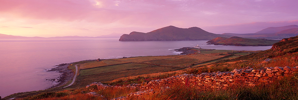 Lighthouse, Beginish island, Doulus Bay and Doulus Head in the distance, at sunset, viewed from Valentia island, Ring of Kerry, Munster, Republic of Ireland, Europe