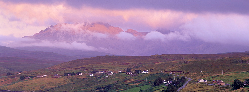 Croftship of Carbost, Loch Harport and the Black Cuillins range in clouds at sunset, Isle of Skye, Inner Hebrides, Highland region, Scotland, United Kingdom, Europe