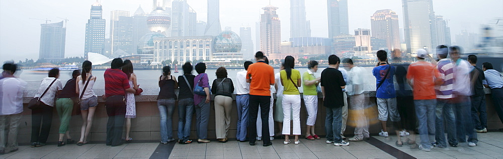 People on the Bund looking over to the Oriental Pearl Tower and the Pudong District, Shanghai, China, Asia