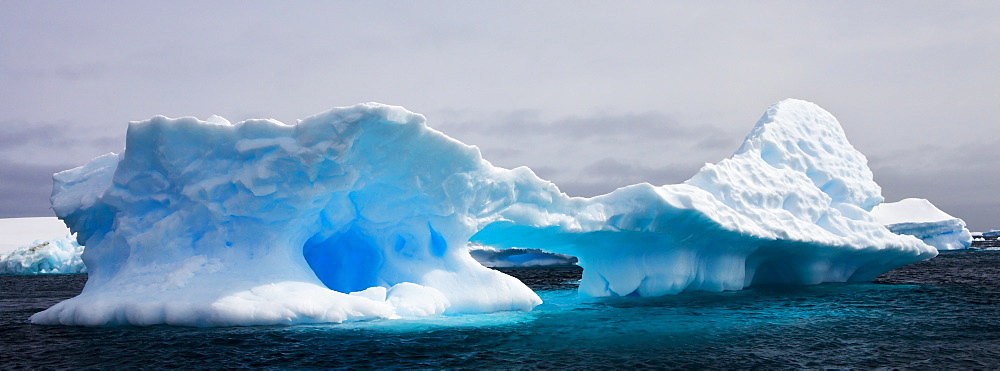 Weathered iceberg in the Iceberg Graveyard off Pleneau Island, Antarctic Peninsula, Antarctica, Polar Regions