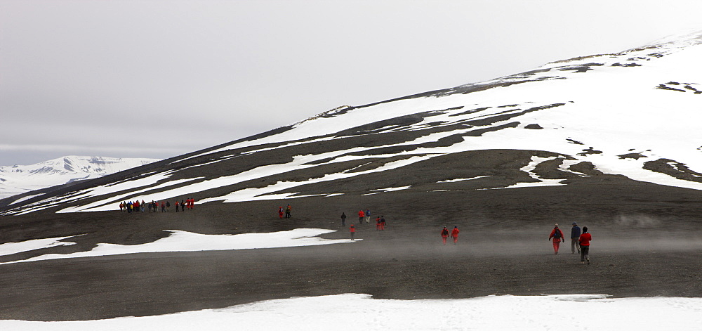 Tourists crossing the mountains that rim the volcanic caldera of Deception Island, South Shetland Islands, Antarctic Peninsula, Antarctica, Polar Regions