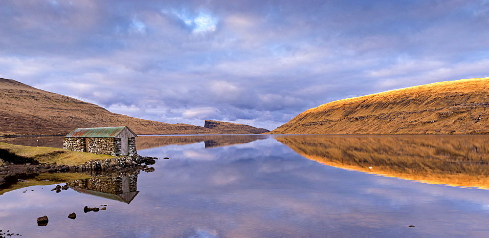 Stone boathouse on the shores of Lake Sorvagur on the island of Vagar, Faroe Islands, Denmark, Europe