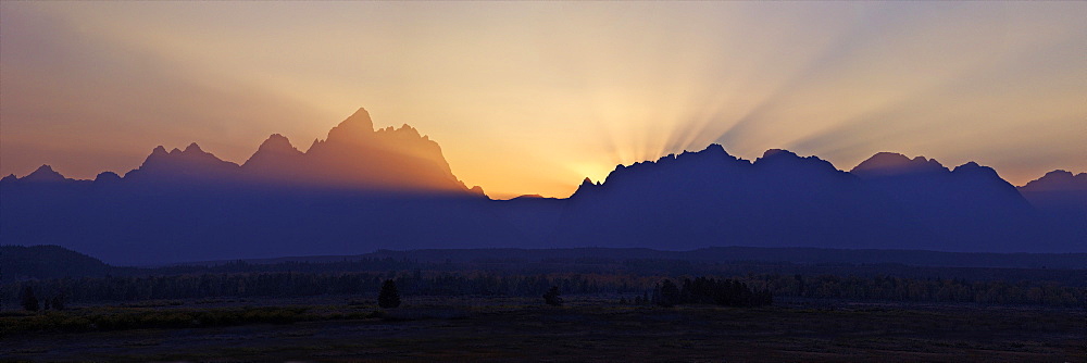 Panoramic photo of sunset over the Cathedral Group of mountains, Grand Teton National Park, Wyoming, United States of America, North America 