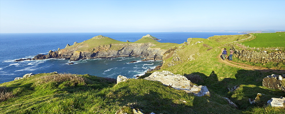 Walking the coastal footpath near the Rumps in spring sunshine, Pentire Headland, Cornwall, England, United Kingdom, Europe