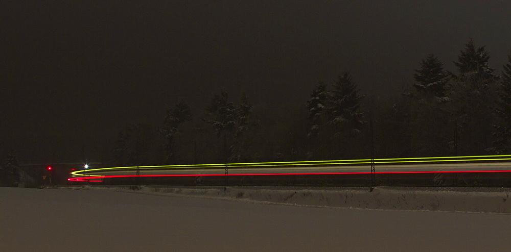 Light trace of a train in winter at night, Beimerstetten, Baden-Wuerttemberg, Germany, Europe