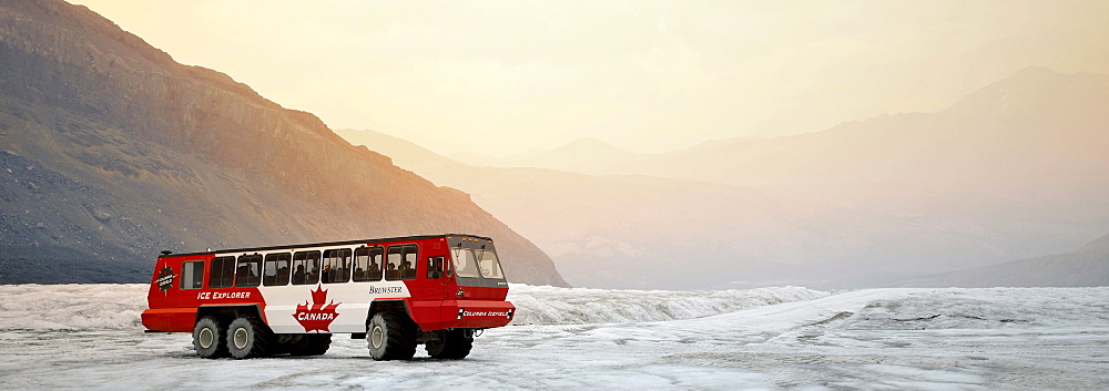 Panorama, special bus of Brewster Ice Explorer Snowcoach, a snow mobile to explore the glacier for tourists, evening mood, Athabasca Glacier, Columbia Icefield, Icefields Parkway, Jasper National Park, Canadian Rockies, Alberta, Canada