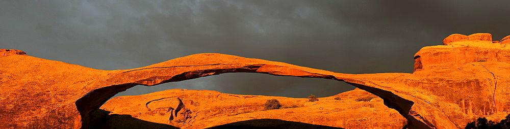 Panorama view, Landscape Arch at sunrise and approaching thunderstorm, Arches National Park, South West, USA