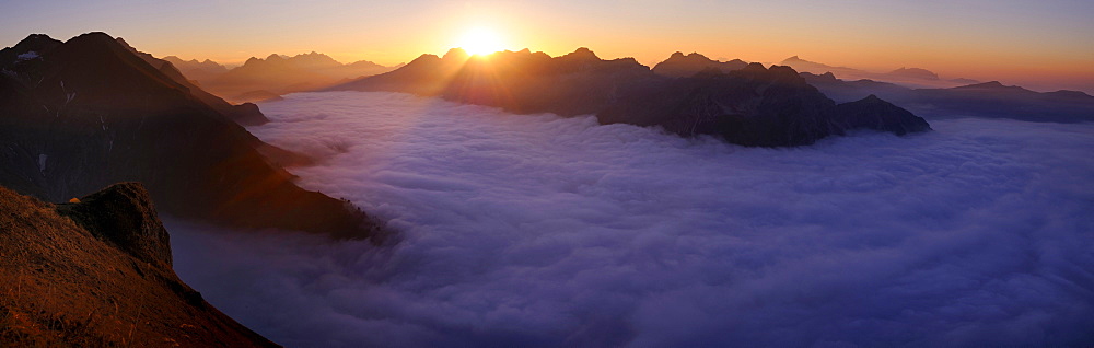 Mountain valley under fog with mountain peaks in the evening light, Allgaeu Alps, Kleinwalsertal valley, Vorarlberg, Austria, Europe