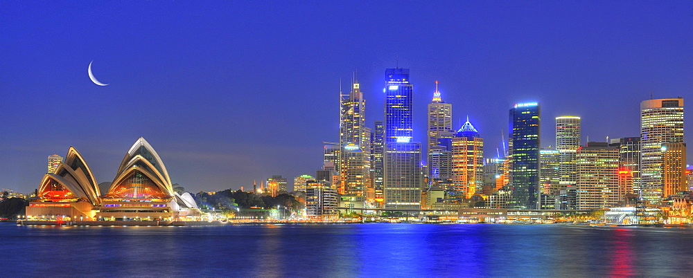 Panorama shot of Sydney Opera House, Sydney Harbour Bridge, Harbour, Sydney skyline, Central Business District, moon, night, Sydney, New South Wales, Australia