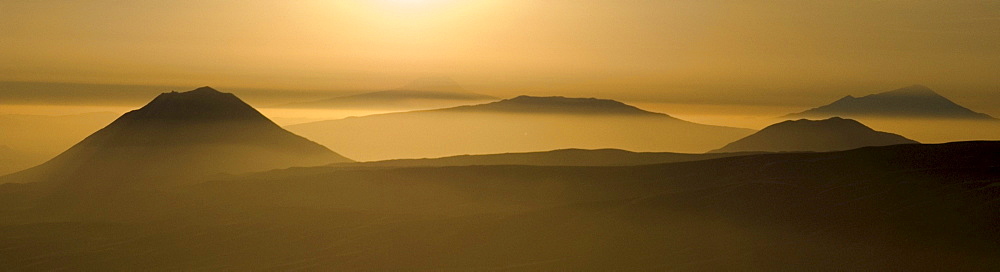 View from Ngorongoro Crater Highlands on Ol Donyo Lengai, Gelai, Keremassi and Mount Meru volcanoes, East African Rift, Tanzania, Africa