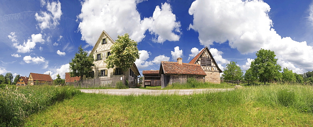 Panorama of an old farming village in the Regnitz region with clouds in the sky village green, Franconian Open-air Museum of Bad Windsheim, Bavaria, Germany, Europe