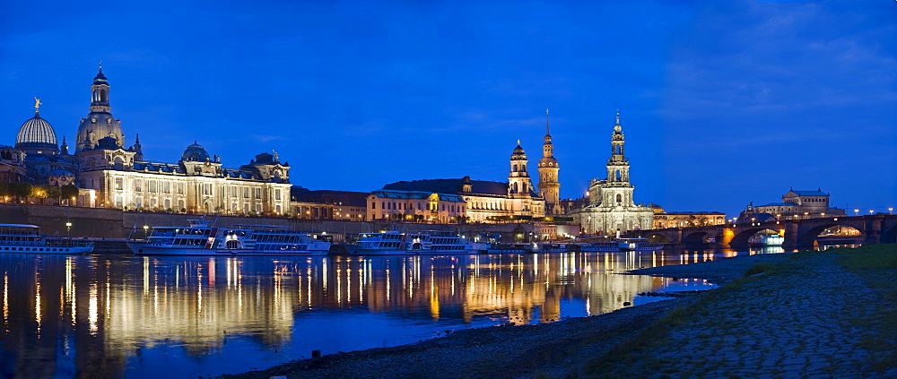 Panoramic city view, Frauenkirche Church, Bruehlsche Terasse, Bruehl's Terrace, Hausmannturm Tower, Hofkirche Church and Semperoper Opera House with reflection in the river Elbe at dusk, Dresden, Saxony, Germany, Europe