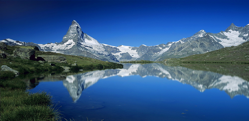 Matterhorn mountain reflecting in Stellisee in summer, Zermatt, Swiss Alps, Switzerland, Europe