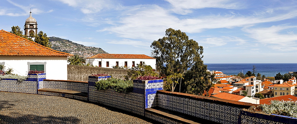 View over a square decorated with Azulejos to the old town and the church tower of the Convento de Santa Clara, Funchal, Madeira, Portugal