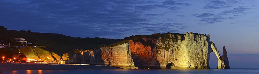 The chalk cliffs of Ã¢Ë†Å¡ÃƒÂ¢tretat with the natural arch Porte dÃ‚Â¬ÃƒÂ­Aval and the needle Aiguille flood-lit at the blue hour after sunset, CÃ¢Ë†Å¡Ã‚Â¥te d'AlbÃ¢Ë†Å¡Ã‚Â¢tre, DÃ¢Ë†Å¡Ã‚Â©partement Seine-Maritime, Haute-Normandie, France, Europe