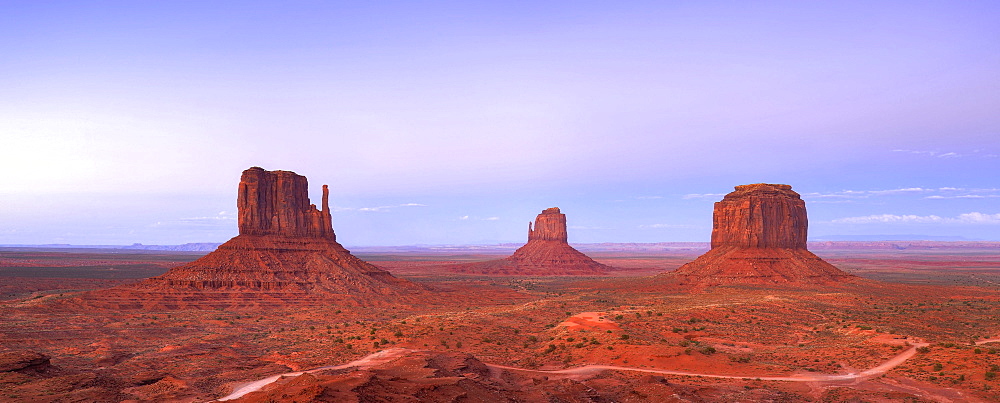 West Mitten Butte, East Mitten Butte and Merrick Butte table mountains and Scenic Drive in the evening light, Monument Valley, Navajo Tribal Park, Navajo Nation Reservation, Arizona, Utah, United States of America