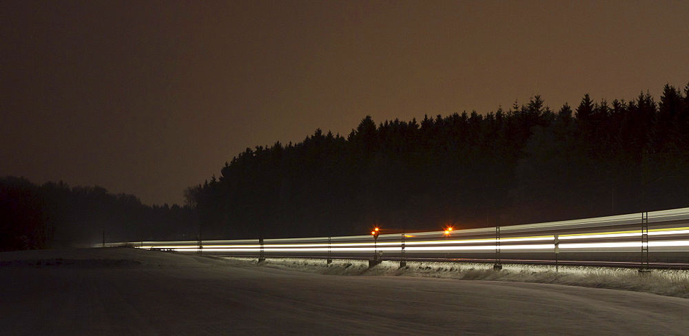 Train as a light trace in winter at night, Beimerstetten, Baden-Wuerttemberg, Germany, Europe