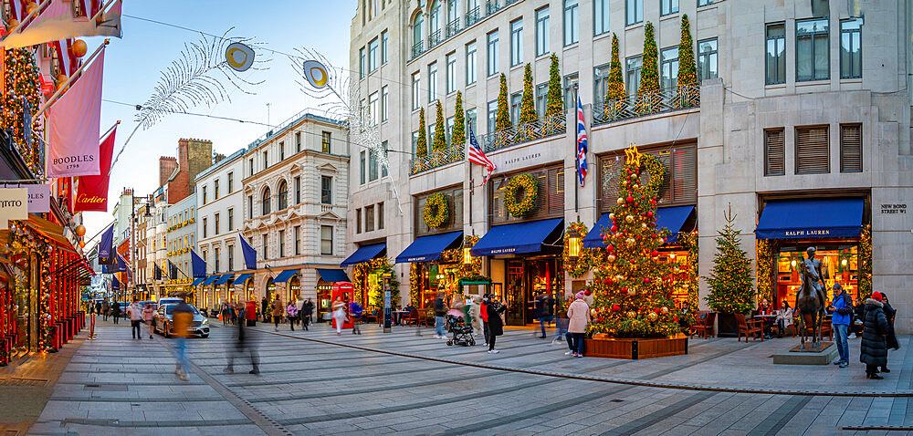 View of Christmas decorations, Christmas tree and shops on New Bond Street at Christmas, London, England, United Kingdom, Europe