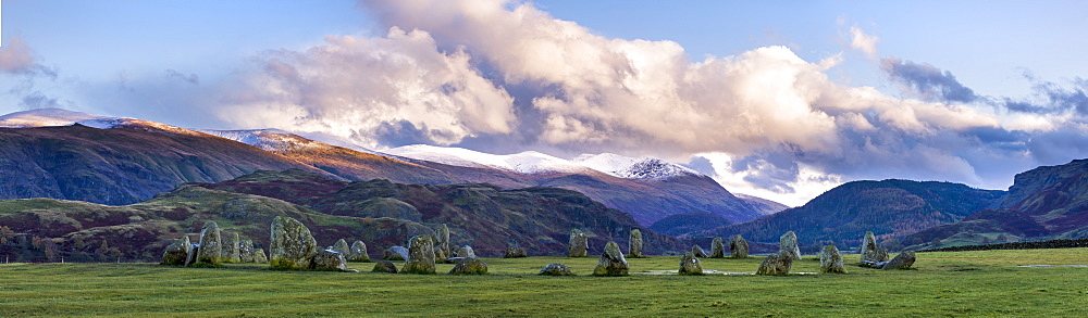 Castlerigg Stone Circle in autumn with Raven Cragg to the right and the snow topped Helvellyn mountain range in the distance, Lake District National Park, Cumbria, England, United Kingdom, Europe