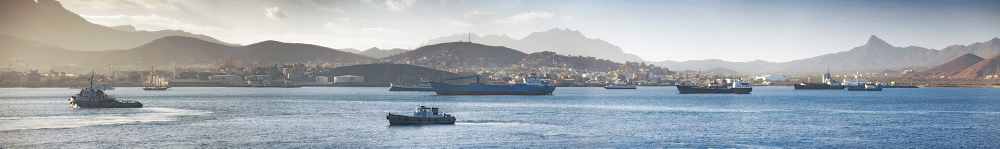 04/04/2009, Early morning, Mindelo Harbour, Tug boat, Cargo ships with mindelo and surrounding mountains, Panoramic. Mindelo, Mindelo Harbour, Sao Vicente Island. Cape Verde Islands