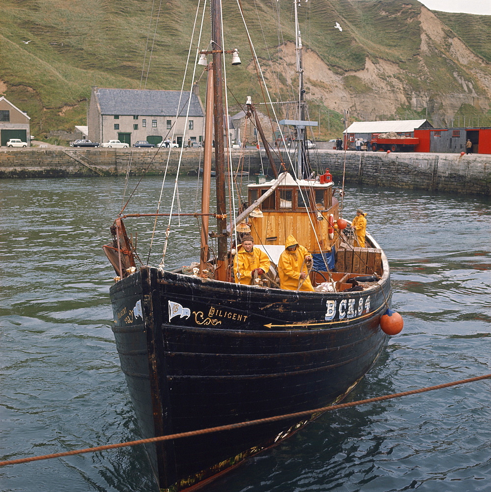 Fishermen on boat leaving Scrabster, Caithness, Scotland, United Kingdom, Europe