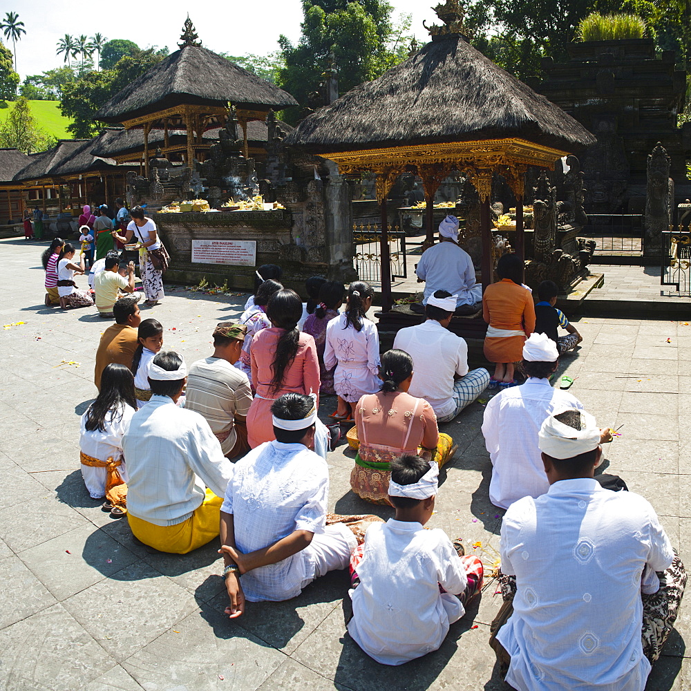 Group of Hindu people praying at Pura Tirta Empul Temple, Bali, Indonesia, Southeast Asia, Asia