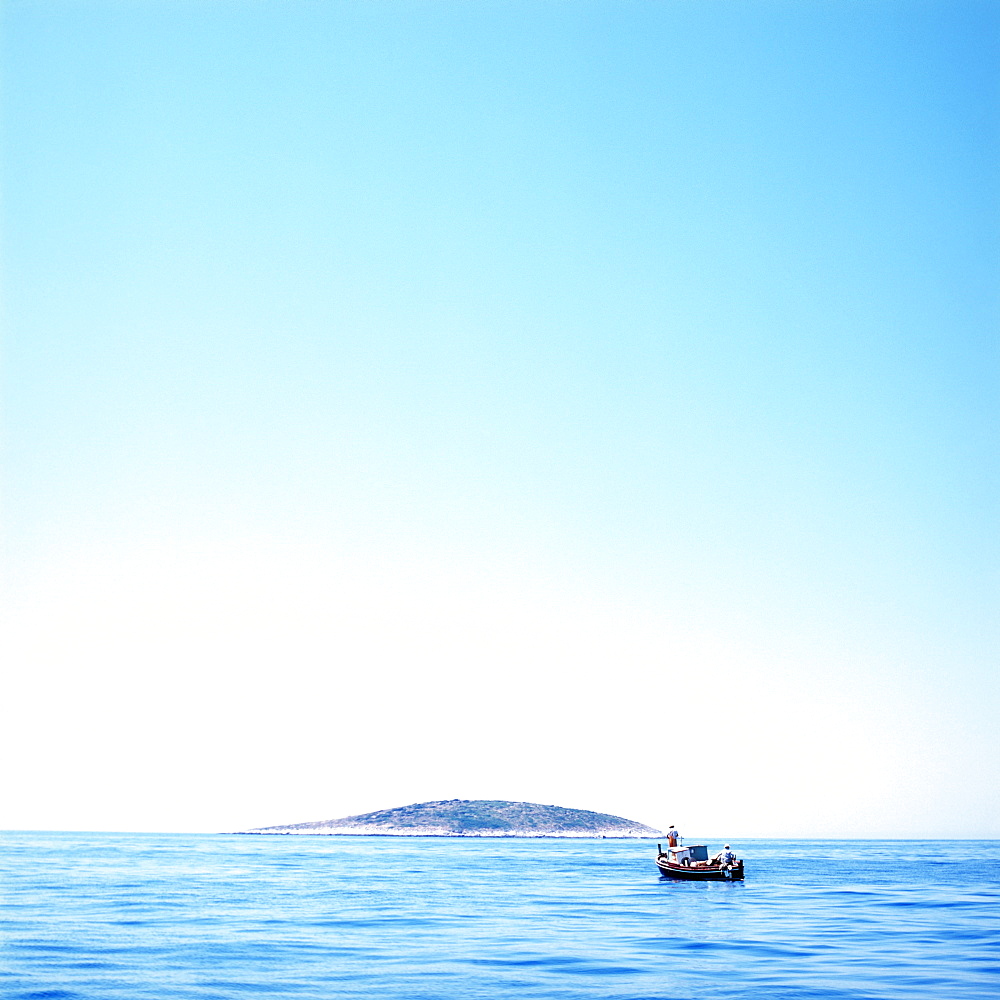 Small fishing boat on Adriatic Sea, island in background, Dalmatia, Croatia