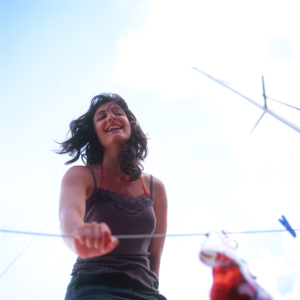 Woman standing on a sailboat and smiling at camera, portrait