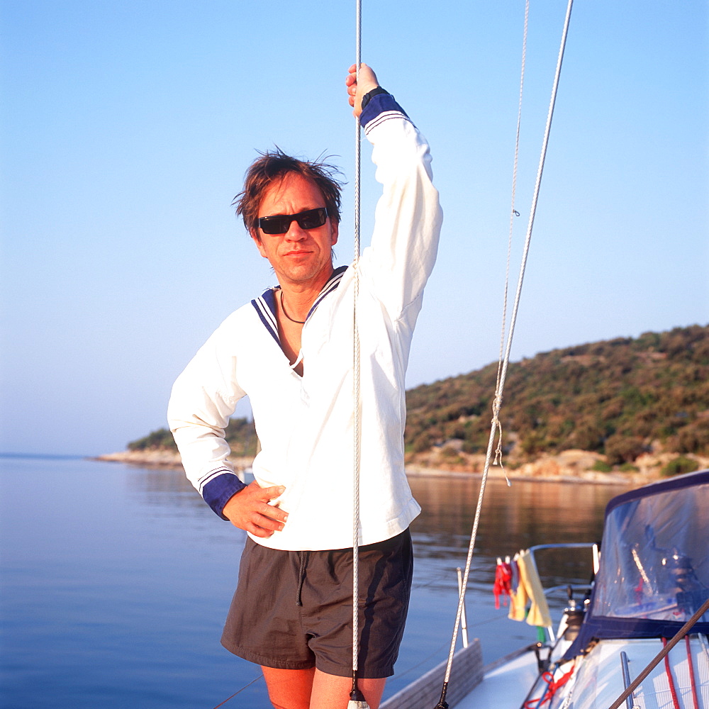 Man wearing sailor suit standing on sailboat, portrait, Adriatic Sea, Dalmatia, Croatia