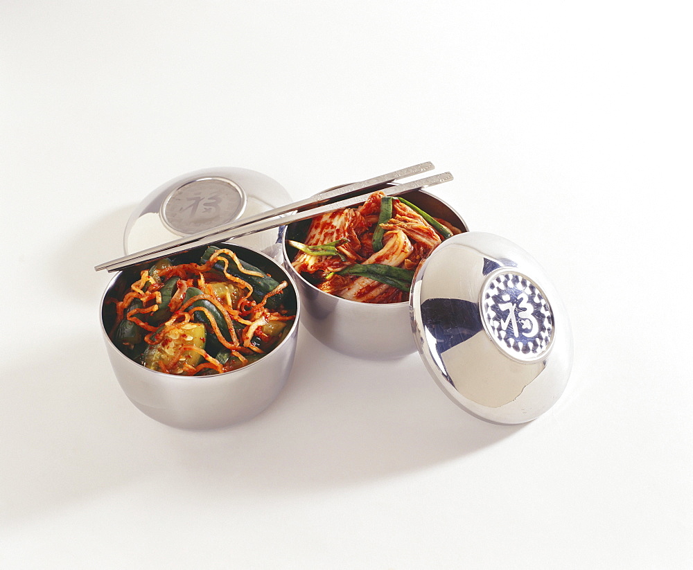 Studio shot of two bowls of kim chee with chopsticks.