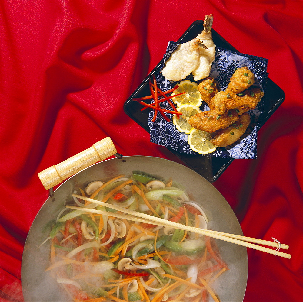 Oriental wok, stir-fry, tempura plate red cloth background B1122