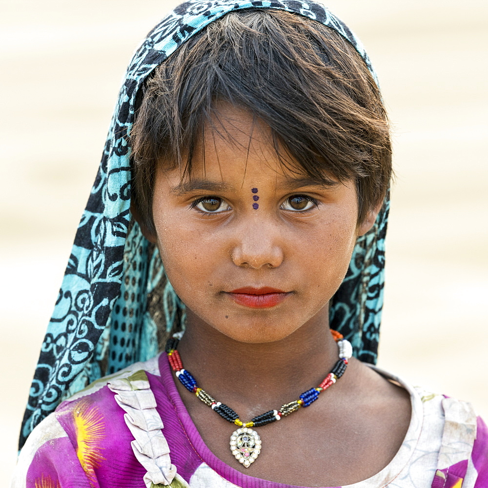 Portrait of a young Indian girl with markings on her face, Damodara, Rajasthan, India