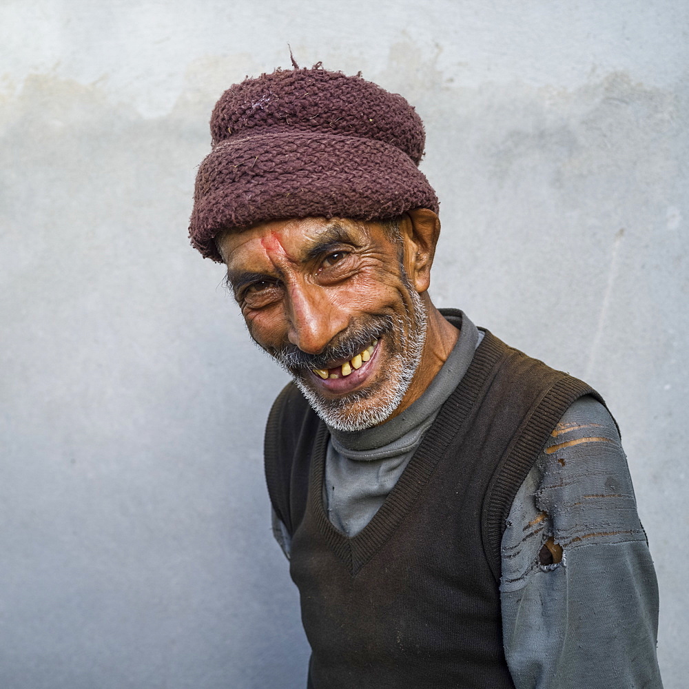 Portrait of an Indian man with a toothy grin and wearing a hat, Radhu Khandu Village, Sikkim, India