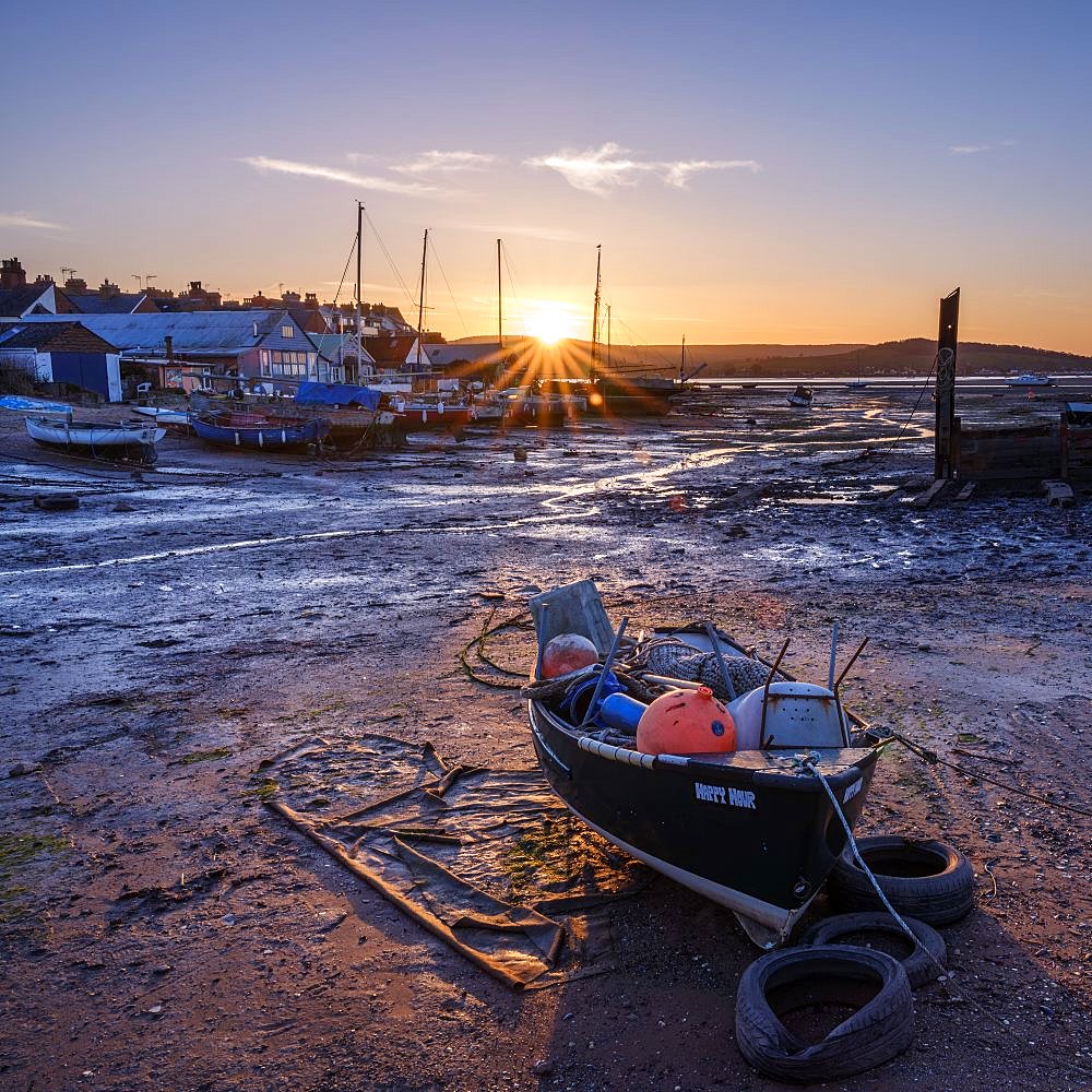 The sun sets behind the boats at Camperdown, Exmouth, Devon , UK