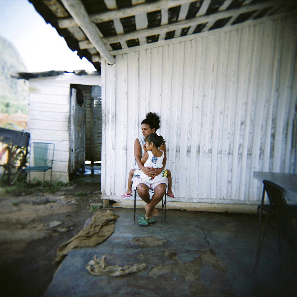 Mother and daughter on porch of their farm, Vinales, Cuba, West Indies, Central America