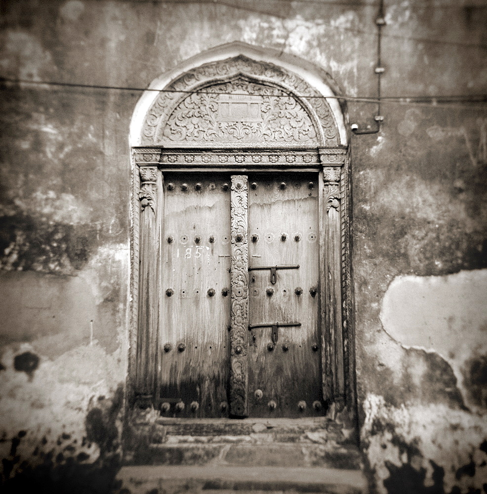 Image taken with a Holga medium format 120 film toy camera of old Omani studded timber door, Stonetown, Zanzibar, Tanzania, East Africa, Africa