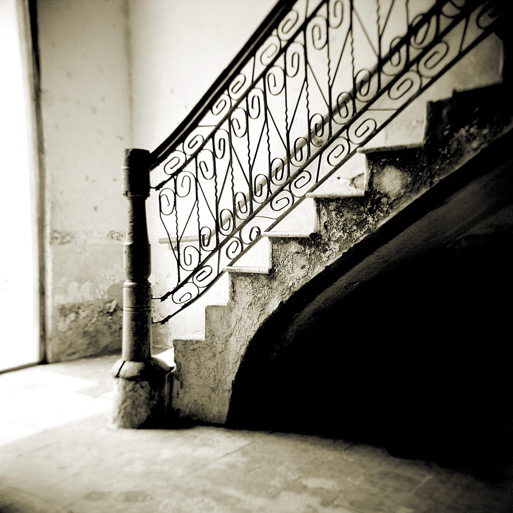 Image taken with a Holga medium format 120 film toy camera of stairs with ornate ironwork inside apartment building, Cienfuegos, Cuba, West Indies, Central America